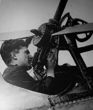 Bishop in the cockpit, holding a Lewis gun
